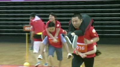 Couples take part in the wife-carrying race