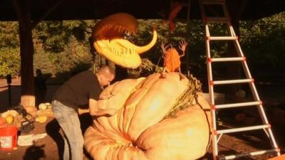 Man carving pumpkin