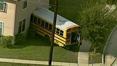 School bus crashes into house