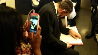 Orthodox Jew studies the Talmud on a commuter train