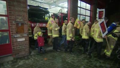 Fire fighters leave their York station