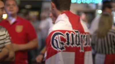 Fans wearing England flags