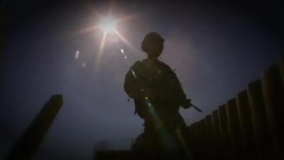 Silhouette of anonymous soldier with gun