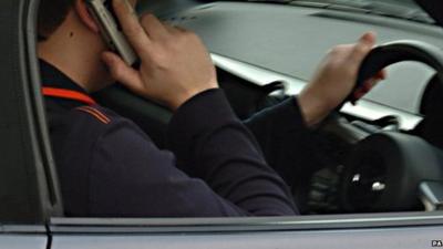 Man using phone whilst driving