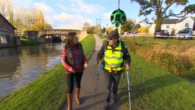 Volunteer with 360 degree camera backpack