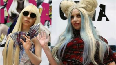 Lady Gaga with one of the dolls from the exhibition