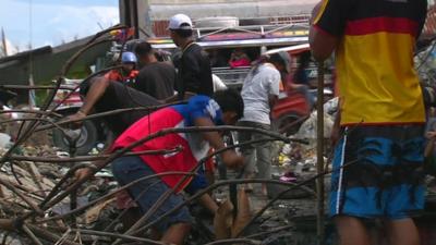 Young men helping with the clean-up in Tacloban's debris-filled streets