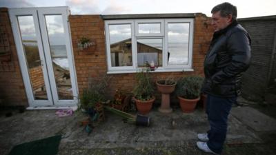 Steve Connelly looks at the remains of his home