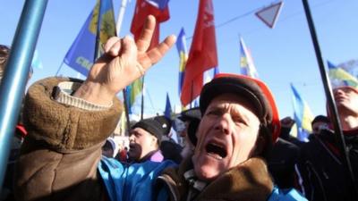 A protester displays the V-sign