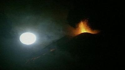 Mount Etna eruption in view of moon