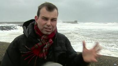 BBC reporter James Cook buffeted by the winds in Ayrshire, Scotland