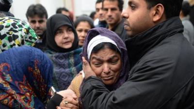 Fatima Khan comforted by mourners