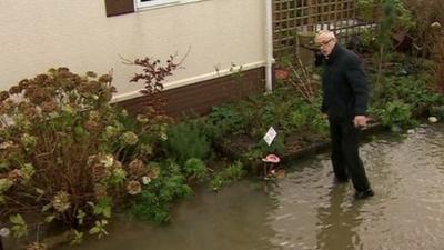 Patrick Pope outside his flooded home