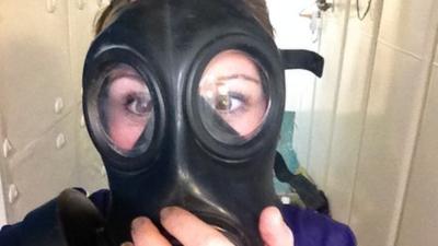 Anna Holligan tries on a gas mask