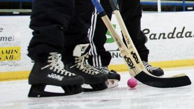 Ice skater playing bandy