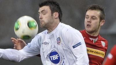 Coleraine's Eoin Bradley shields the ball from Cliftonville's Jamie McGovern