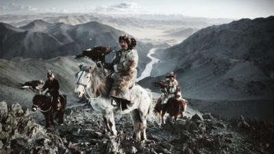 Kazakh eagle hunters on horseback