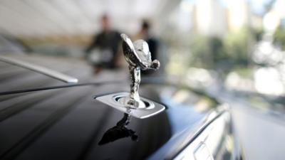 A Rolls-Royce mascot known as the "Spirit of Ecstasy" stands on the front of a Rolls-Royce Ghost in a showroom in Singapore October 8, 2013