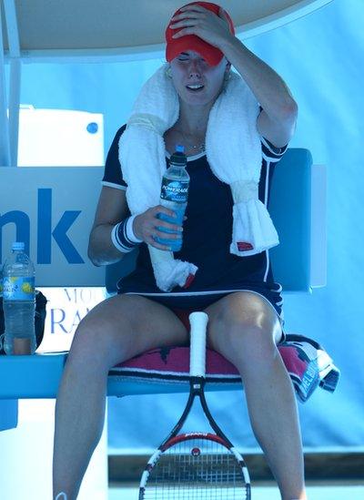 Alize Cornet of France cries between games while trying to deal with the extreme heat