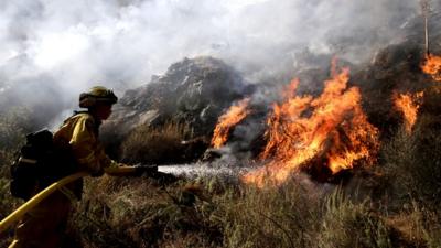 Firefighter tackles California fires