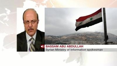 A photo of Bassam Abu Abdullah and a Syrian flag