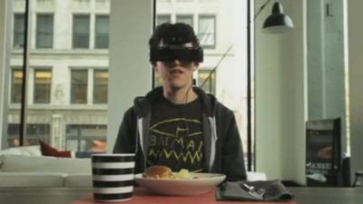 boy sat at a table wearing a headset