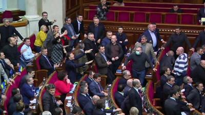 Politicians shouting and waving in parliament