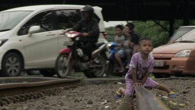 boy playing on train tracks