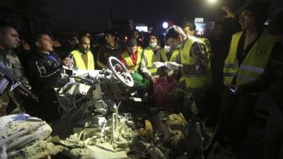 Civil defence members and Lebanese Army soldiers inspect the wreckage of a van at the site of an explosion in Choueifat, south of the capital on 3 February 2014.