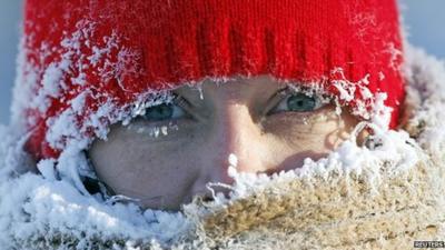 A woman in a hat and scarf