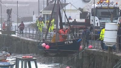 Boats winched from Porthleven Harbour