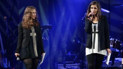 Maria Alyokhina (L) and Nadezhda Tolokonnikova of Pussy Riot speak onstage at the Amnesty International Concert presented by the CBGB Festival at Barclays Center 5 February 2014