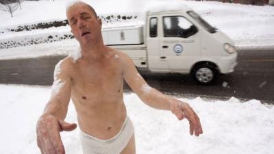 A statue by Tony Matelli titled "Sleepwalker" stands in the snow on the campus of Wellesley College in Wellesley, Massachusetts