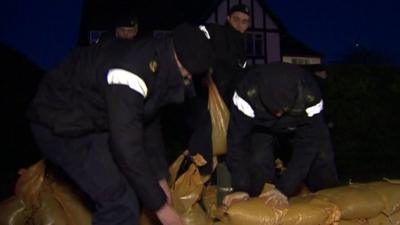 Royal Navy personnel build sandbag wall