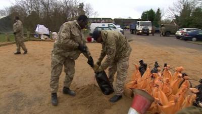 Soldiers filling sandbags