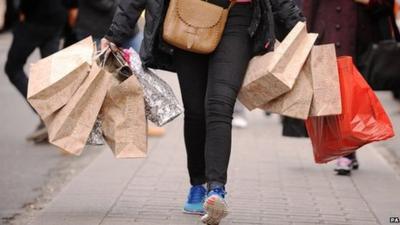 A shopper carrying shopping bags