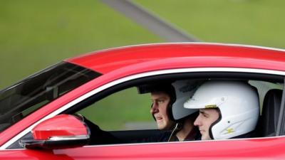 Prince Harry drives red car