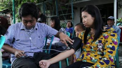 A woman having her blood pressure taken