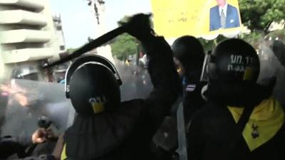 Riot police confronting protesters in Bangkok