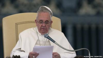 A gust of wind blows away the Pope's skullcap as he gives his weekly general audience in St Peter's Square on 19 February 2014