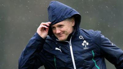 Joe Schmidt takes cover from the rain during Ireland's training session on Thursday