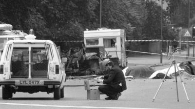 Dead horses covered up and wrecked cars at the scene of carnage in Rotten Row, Hyde Park, after an IRA bomb exploded as the Household Cavalry was passing