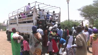 New arrivals climbing off truck