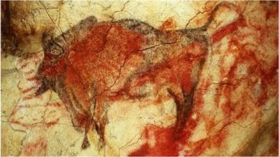 A painting of a large male bison on the ceiling of the caves' polychrome chamber, shown in a 1985 file photo