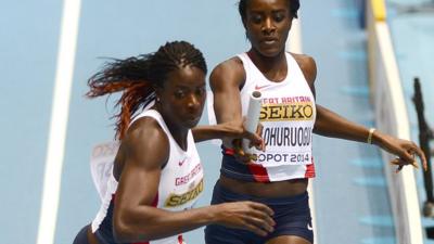 Great Britain's Christine Ohuruogu (L) receives the baton from Great Britain's Victoria Ohuruogu