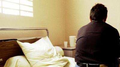 Man sitting on hospital bed