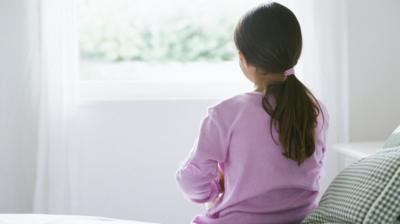 Girl sitting on bed