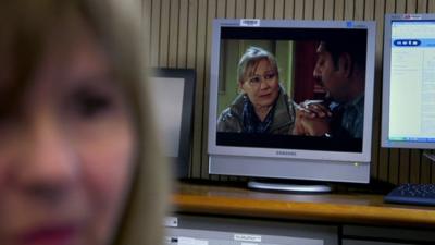 TV showing Eastenders inside the National Grid control room