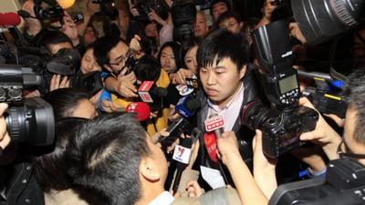 A relative answers media questions at Lido Hotel in Beijing