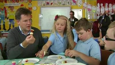 Nick Clegg eating with schoolchildren